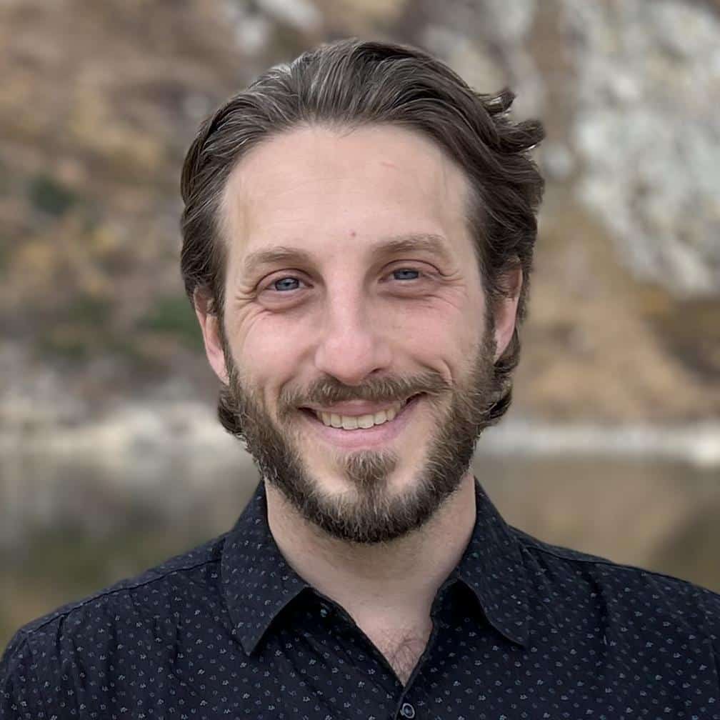 Warm professional therapist portrait in office, Micah Fleitman, LPC, Virginia, EMDR therapist Arlington, trauma specialist