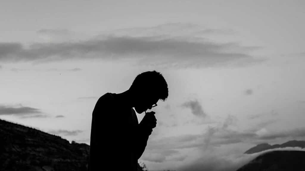 silhouette photo of man smoking outdoor