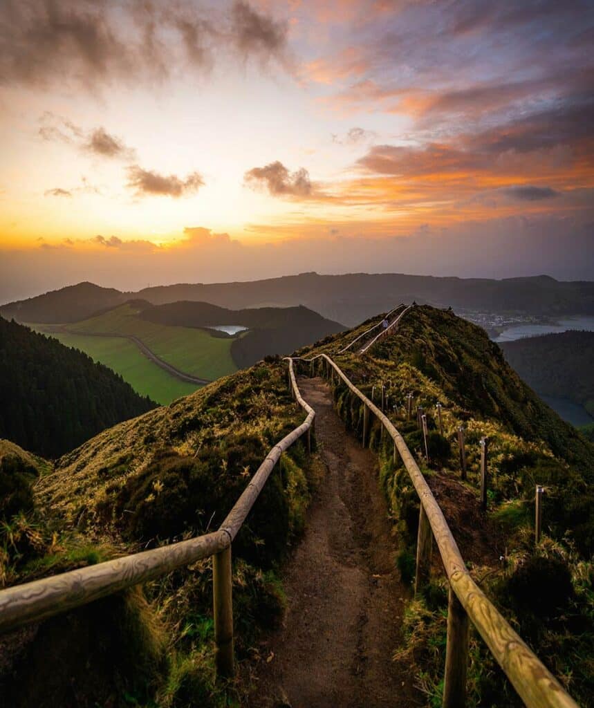 Mountain bridge at sunrise with soft light stretching across the scene, symbolizing transition, balance, and forward movement