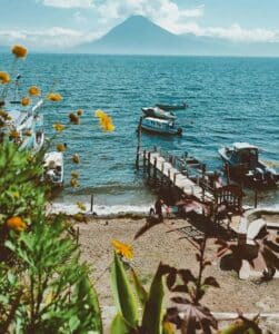 Dock with ships resting along the water, calm reflections, and open space creating a quiet, steady, and grounding scene