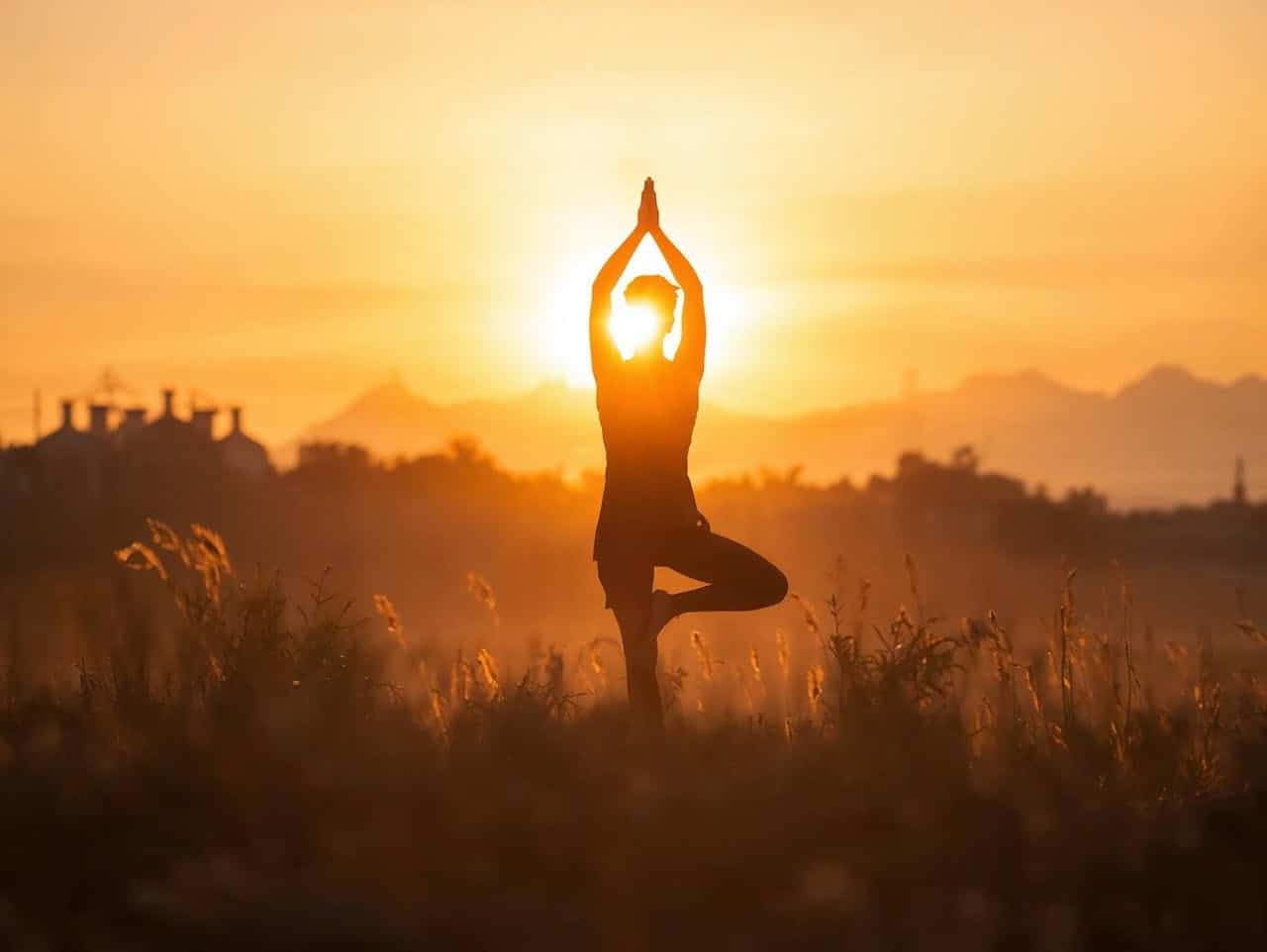 Person practicing grounding and breathwork at sunrise to support trauma healing through somatic therapy